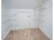 Walk-in closet with white wire shelving and neutral carpeting at 6203 Crestview Drive Southeast Se Dr, Covington, GA 30014