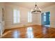 Spacious dining room featuring hardwood floors, ample natural light, and a modern chandelier at 6203 Crestview Drive Southeast Se Dr, Covington, GA 30014