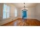 Dining room featuring hardwood floors, white walls, plantation shutters and modern chandelier at 6203 Crestview Drive Southeast Se Dr, Covington, GA 30014