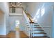 Grand foyer with hardwood floors, an elegant staircase, and high ceilings featuring detailed trim at 6203 Crestview Drive Southeast Se Dr, Covington, GA 30014