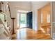 Open front door leading to a bright foyer with hardwood floors and staircase at 6203 Crestview Drive Southeast Se Dr, Covington, GA 30014