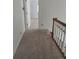 Bright hallway featuring neutral carpeting and classic white trim at 6203 Crestview Drive Southeast Se Dr, Covington, GA 30014