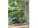Water feature framed by stonework and lush greenery offers a tranquil backyard retreat at 6203 Crestview Drive Southeast Se Dr, Covington, GA 30014