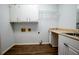 Functional laundry room with sink, countertop, and storage cabinets at 6203 Crestview Drive Southeast Se Dr, Covington, GA 30014