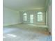 Bright living room with large windows and plush carpeting; perfect for relaxing and entertaining at 6203 Crestview Drive Southeast Se Dr, Covington, GA 30014
