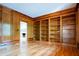 Spacious living room features hardwood floors, wood wall paneling, and built-in bookshelves at 6203 Crestview Drive Southeast Se Dr, Covington, GA 30014