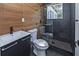 Modern bathroom featuring wood accent wall, frameless shower, and sleek vanity at 672 Quillian Ave, Decatur, GA 30032