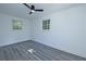 Bright bedroom with gray laminate flooring, large windows, and ceiling fan at 672 Quillian Ave, Decatur, GA 30032