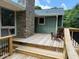 Spacious deck with a brick chimney, wood railing, stairs, and an Adirondack chair at 6878 Vic Ar Rd, Atlanta, GA 30360