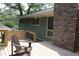 Inviting back deck features wood railing, a brick chimney, and a relaxing Adirondack chair at 6878 Vic Ar Rd, Atlanta, GA 30360