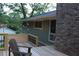 Comfortable back deck featuring string lights, a brick chimney, and a green exterior at 6878 Vic Ar Rd, Atlanta, GA 30360