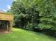 A spacious backyard features lush green grass and a wooden deck, perfect for outdoor relaxation and entertainment at 6878 Vic Ar Rd, Atlanta, GA 30360