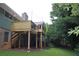 Elevated backyard deck features wood railings, stairs, and views of the landscaped yard at 6878 Vic Ar Rd, Atlanta, GA 30360