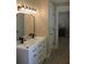 Modern bathroom with double vanity and decorative lighting fixtures, for comfort and convenience at 6878 Vic Ar Rd, Atlanta, GA 30360