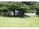 Charming single-story home with well-maintained lawn and mature shade tree in a quiet residential neighborhood at 6878 Vic Ar Rd, Atlanta, GA 30360