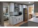 Modern kitchen with stainless appliances, granite counters, and pass through view to the living room at 6878 Vic Ar Rd, Atlanta, GA 30360