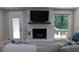Living room features a white painted brick fireplace with a flat screen television and access to the deck at 6878 Vic Ar Rd, Atlanta, GA 30360