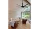 Bright living room featuring hardwood floors, vaulted ceilings, and a large window with backyard view at 6878 Vic Ar Rd, Atlanta, GA 30360