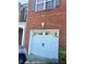 Attached garage with arched entry and carriage style door matches the red brick home's exterior at 1870 Garbrooke, Lawrenceville, GA 30046