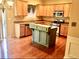 Kitchen features an island, stainless appliances, and light wood cabinets at 1870 Garbrooke, Lawrenceville, GA 30046