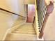 Carpeted staircase with natural wood banister leads to the lower level of the home at 1870 Garbrooke, Lawrenceville, GA 30046