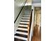 Carpet free staircase with wood treads and painted risers lead to the upper level of the home at 1870 Garbrooke, Lawrenceville, GA 30046