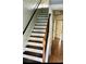Carpet free staircase with wood treads and painted risers lead to the upper level of the home at 1870 Garbrooke, Lawrenceville, GA 30046