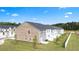 Backyards of homes with green grass, young trees and privacy fences at 225 Silver Moon Dr, Loganville, GA 30052