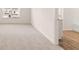Spacious bedroom with plush carpeting and a view to the bathroom, providing a comfortable and inviting retreat at 225 Silver Moon Dr, Loganville, GA 30052