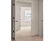 Bright carpeted bedroom showing natural light. Adjacent bath access door open at 225 Silver Moon Dr, Loganville, GA 30052