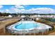 A community pool area with a clubhouse, lounge chairs, and a playground at 225 Silver Moon Dr, Loganville, GA 30052