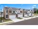New townhomes with private garages, modern exteriors, sidewalks, and professionally landscaped yards at 225 Silver Moon Dr, Loganville, GA 30052