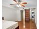 Bedroom featuring wood floors, ceiling fan, and barn door leading to a laundry area at 3650 Ashford Dunwoody Ne Rd # 413, Atlanta, GA 30319
