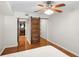 Bedroom featuring wood floors, ceiling fan and rustic barn door to the bathroom at 3650 Ashford Dunwoody Ne Rd # 413, Atlanta, GA 30319