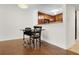 Bright dining area featuring hardwood floors, modern lighting, and a view into the cozy kitchen at 3650 Ashford Dunwoody Ne Rd # 413, Atlanta, GA 30319
