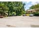 Ample parking space in front of well-maintained buildings surrounded by mature trees, showcasing convenience at 3650 Ashford Dunwoody Ne Rd # 413, Atlanta, GA 30319
