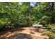 Community picnic area with grill and tables nestled amongst mature trees at 3650 Ashford Dunwoody Ne Rd # 413, Atlanta, GA 30319