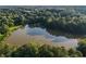 Bird's eye view of a pond reflecting the sky, embraced by a forest, and green space at 1077 Mainstreet Valley Dr, Stone Mountain, GA 30088