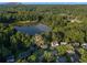 A high altitude aerial shot shows a lake surrounded by thick forest and several homes at 1077 Mainstreet Valley Dr, Stone Mountain, GA 30088