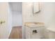 Modest bathroom with white cabinet sink adjacent to the commode and doorway to the bedroom at 1077 Mainstreet Valley Dr, Stone Mountain, GA 30088