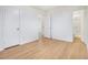 Bedroom featuring hardwood flooring, doors, and natural light at 1077 Mainstreet Valley Dr, Stone Mountain, GA 30088