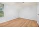 Bright bedroom featuring hardwood flooring, natural light, and white walls for a clean, modern appeal at 1077 Mainstreet Valley Dr, Stone Mountain, GA 30088