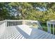 Looking out from the deck to a leafy backyard and shade trees with lake visible in background at 1077 Mainstreet Valley Dr, Stone Mountain, GA 30088