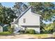 View of the side of a charming grey home with white trim and green landscaping at 1077 Mainstreet Valley Dr, Stone Mountain, GA 30088