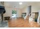 Open-concept living room with hardwood floors, fireplace, and access to outdoor deck at 1077 Mainstreet Valley Dr, Stone Mountain, GA 30088