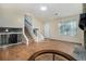 Spacious living room featuring wood floors, a stone fireplace, and ample natural light at 1077 Mainstreet Valley Dr, Stone Mountain, GA 30088