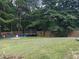 View of a fenced backyard with play equipment on a level, green lawn at 20 Bacchus Dr, Lawrenceville, GA 30045