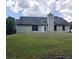 Exterior view of a home and back yard featuring a gentle slope, and white trim at 20 Bacchus Dr, Lawrenceville, GA 30045
