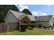 A quaint single-story home featuring a red brick accent wall, a screened porch, and a well-kept lawn at 20 Bacchus Dr, Lawrenceville, GA 30045