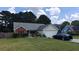Charming single-story home with a well-manicured lawn, a screened porch, and an attached two-car garage at 20 Bacchus Dr, Lawrenceville, GA 30045